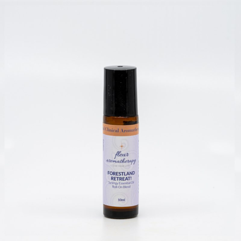 A roll on bottle of essential oil sitting next to a white wall.