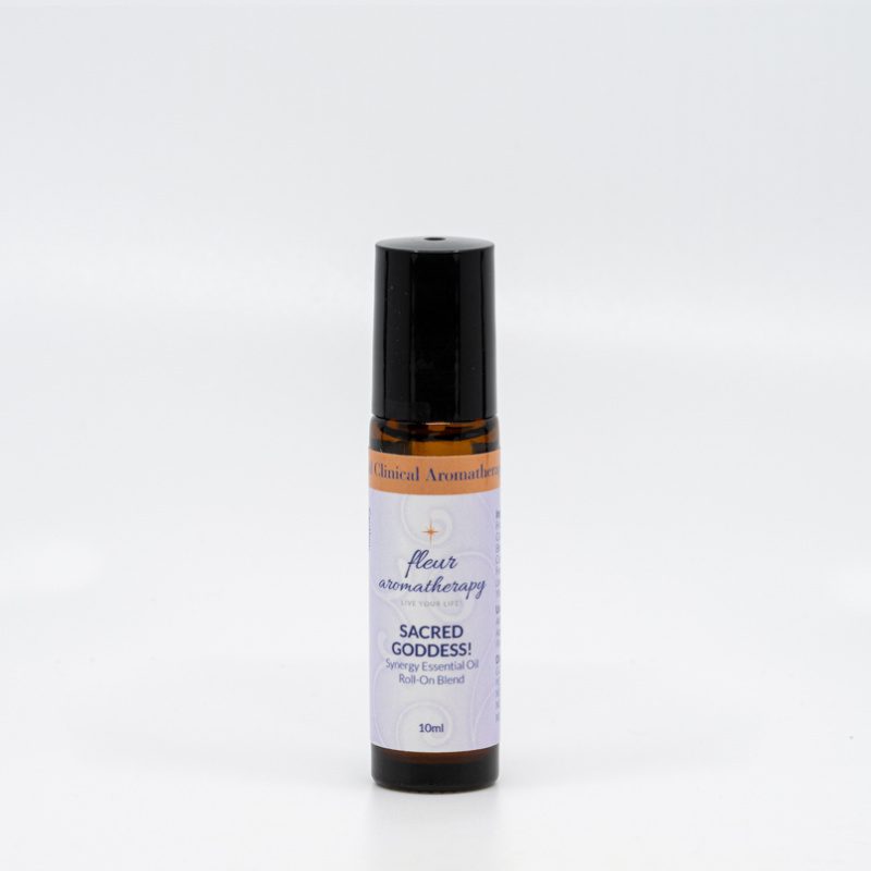 A roll on bottle of essential oil sitting next to a white wall.