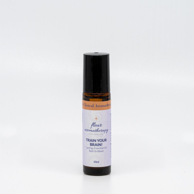 A roll on bottle of essential oil sitting next to a white wall.